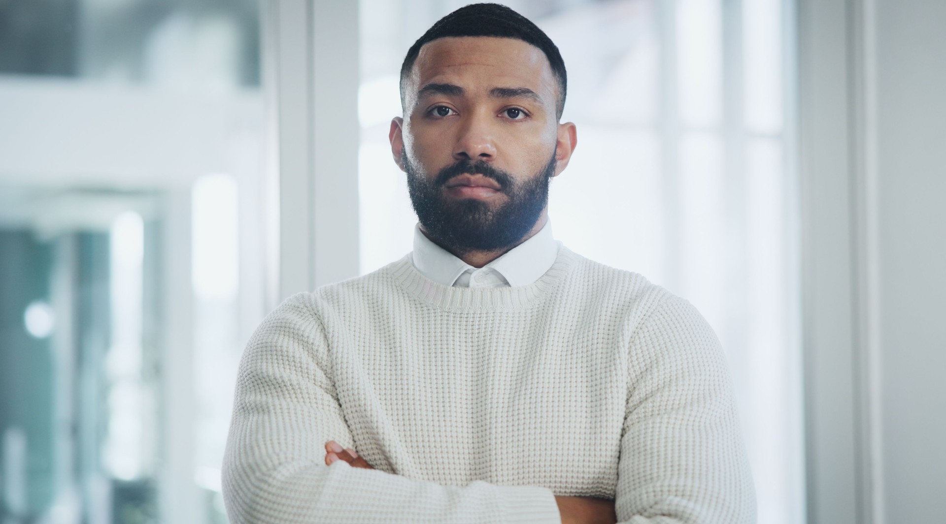 Businessman, portrait and serious with arms crossed in office for recruitment confidence and startup company. Human resources, employee and professional person with pride for hiring and about us