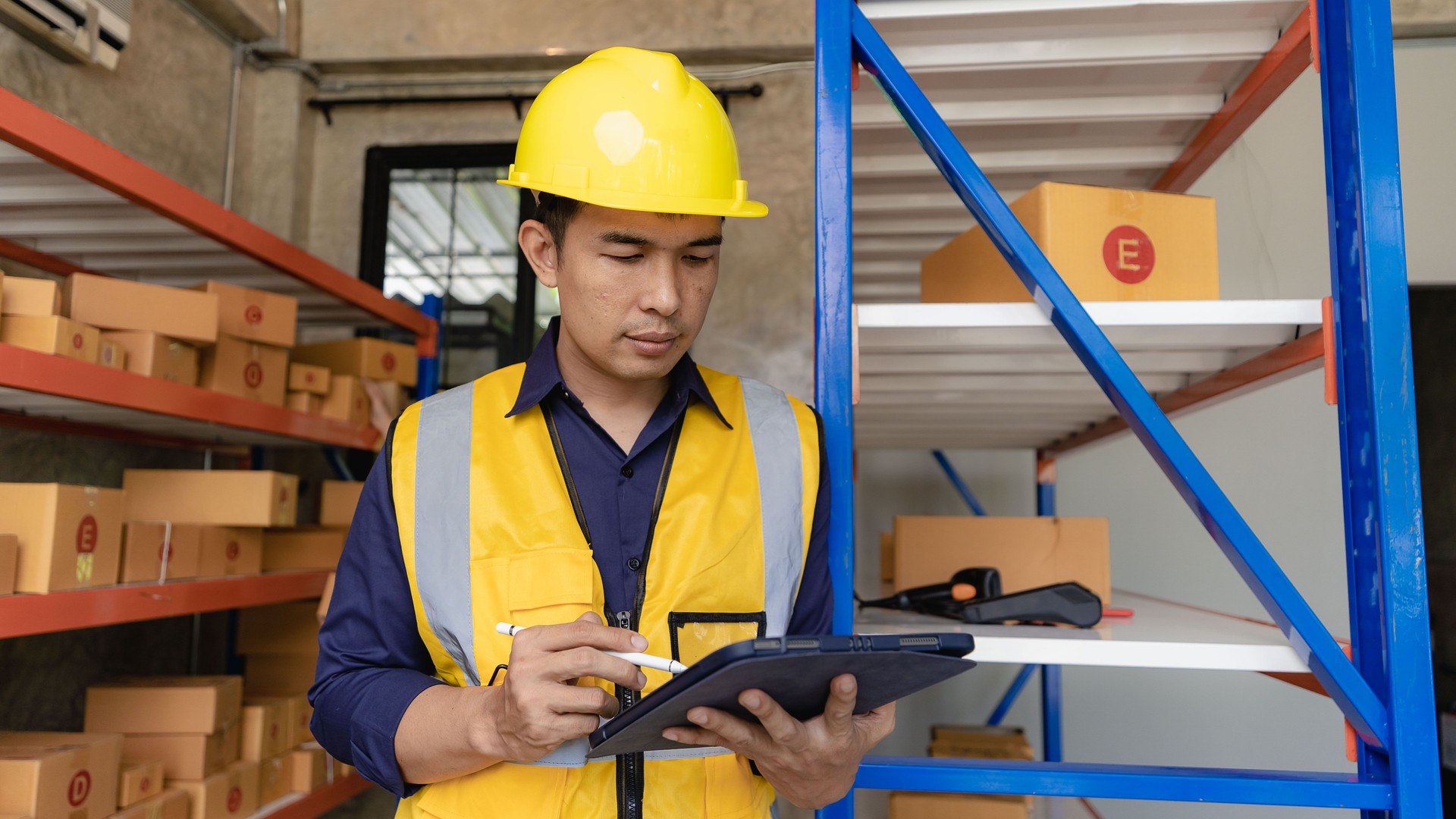 Asian man managing warehouse worker man holding tablet in warehouse Logistics network distribution and intelligent logistics, import, export, and industrial concepts..box transport